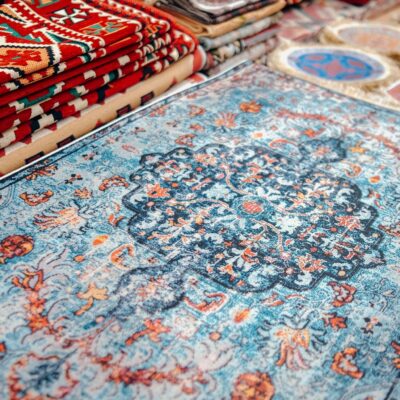 A collection of traditional handmade carpets with vibrant patterns on display.