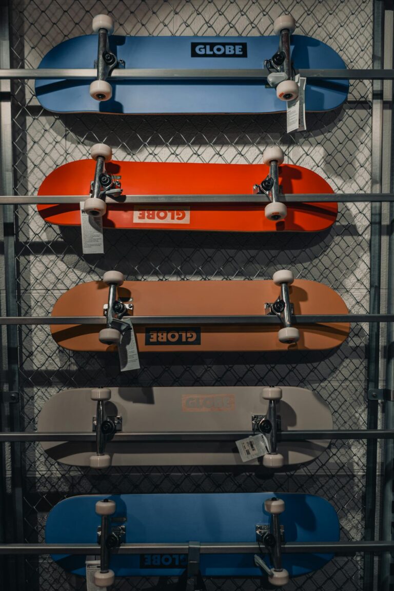 Vibrant skateboard collection displayed vertically in a modern skateshop setting.